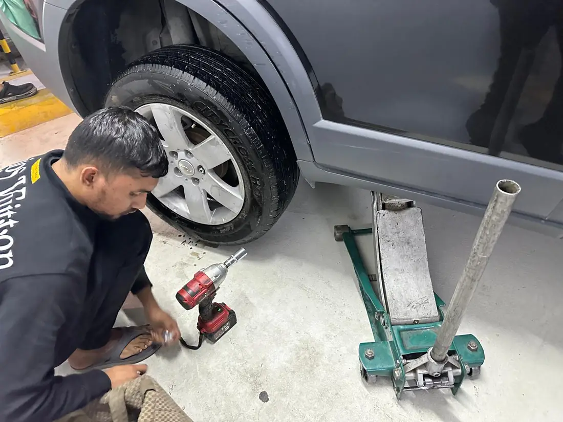 Jack and tools set up under a car