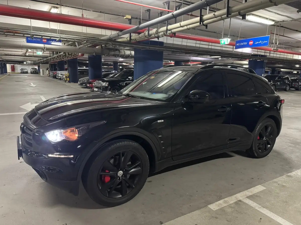 Black Infiniti in a car park after a tyre job